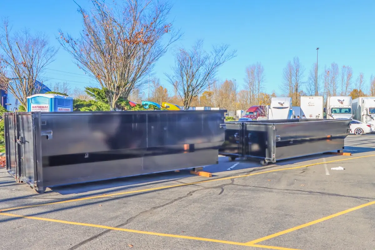 Professional dumpster rental service with roll-off container on residential driveway in Pea Ridge